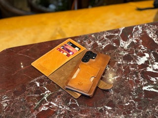 Galaxy S26 Ultra in a Venito Florence leather wallet case on a wooden table