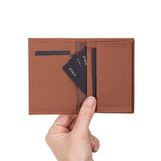 Hand holding a Venito full-grain leather card holder